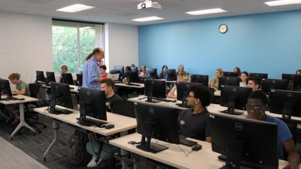 a group of people in a room with computers